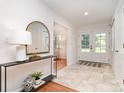 Bright foyer with tiled floors, a console table, and double doors leading outside at 5424 Doncaster Dr, Charlotte, NC 28211