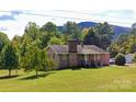 Traditional single-Gathering home boasts a brick facade, front porch, and a lush green lawn at 6229 Mountain Grove Rd, Hickory, NC 28602