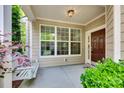 Cozy front porch featuring a swing, neutral paint, and a well-maintained entrance door at 714 Deerbrook Ln, Tega Cay, SC 29708