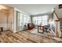 Bright living room with hardwood floors, large windows with blinds, comfortable seating, and a welcoming atmosphere at 714 Deerbrook Ln, Tega Cay, SC 29708