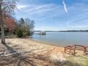 Sandy beach on the lake, complete with a wooden deck and a covered pier for enjoying the waterfront at 714 Deerbrook Ln, Tega Cay, SC 29708