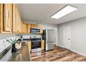 The kitchen has stainless steel appliances, wood cabinets, and a granite countertop at 729 Tenth Ne Ave, Hickory, NC 28601