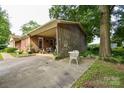 Brick ranch home with covered carport, and outdoor seating, perfect for enjoying the outdoors at 7518 Surry Ln, Indian Trail, NC 28079