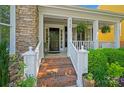 Welcoming front porch with brick steps, white railings, and lush landscaping at 8109 Hawk Crest Ct, Charlotte, NC 28270