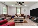 Comfortable living room featuring wood-look flooring, a ceiling fan, and natural light at 812 Kings Rd, Shelby, NC 28150