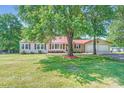 Quaint home featuring a red roof, attached two-car garage, and a lush green lawn at 8255 Castor Rd, Salisbury, NC 28146