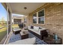 Inviting screened porch featuring comfortable seating, a ceiling fan, and views of the backyard at 9435 Liberty Hill Dr, Mint Hill, NC 28227