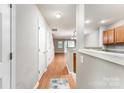 Bright hallway with hardwood floors, neutral walls, and seamless flow to the kitchen and living spaces at 10223 Reindeer Way Ln, Charlotte, NC 28216