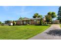Sprawling lawn surrounds this single-story brick home, set back on lot, with detached garage and long driveway at 110 Heritage Dr, Kings Mountain, NC 28086