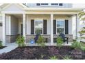 Inviting front porch with comfortable seating and manicured landscaping at 11116 Godwit Ln, Charlotte, NC 28278