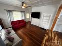 Bright living room features hardwood floors, white trim, and abundant natural light at 208 S Ransom St, Gastonia, NC 28052