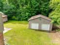 Aerial view of a large, private backyard with a two-car garage, storage shed, and plenty of green space at 2111 Parkdale Ave, Gastonia, NC 28052