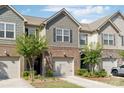 Attractive townhome displaying a combination of brick and shake siding, featuring a single-car garage and verdant landscaping at 344 Kennebel Pl, Fort Mill, SC 29715