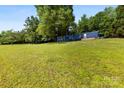 Extensive green lawn, with the mobile home in the distance at 41042 Dennis Rd, Albemarle, NC 28001