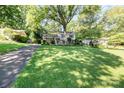 Charming home with a spacious, well-manicured front yard and a mature tree, exuding curb appeal at 4200 Tyndale Ave, Charlotte, NC 28210