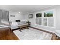 Bright living room with hardwood floors, large windows, and a cozy, neutral-toned aesthetic at 4200 Tyndale Ave, Charlotte, NC 28210