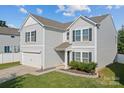 Charming two-story home featuring a gray siding, attached garage, and well-maintained landscaping at 4313 Gibbon Crossing Dr, Charlotte, NC 28269