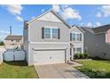 Charming two-story home featuring a gray siding, attached garage, and well-maintained landscaping at 4313 Gibbon Crossing Dr, Charlotte, NC 28269