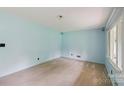 Spacious living room with light blue walls, neutral carpet, and ample natural light at 46 Donna Dale Se Ave, Concord, NC 28025