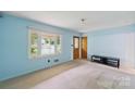 Bright living room with neutral carpet, light blue walls and a view of the front yard at 46 Donna Dale Se Ave, Concord, NC 28025