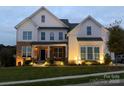Charming home with mixed brick and siding exterior, well-lit entrance, and manicured lawn at 509 Abelia Ln, Tega Cay, SC 29708