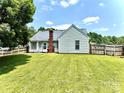 A spacious backyard with a lush green lawn, enclosed by a wooden fence, offering ample space at 5728 Rocbridge Ln, Charlotte, NC 28208