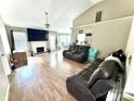 Open living room with a vaulted ceiling, fireplace, and view to the dining area at 5728 Rocbridge Ln, Charlotte, NC 28208