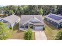 Aerial view of home with manicured lawn in a neighborhood setting with mature trees at 6007 Eleanor Rigby Rd, Charlotte, NC 28278