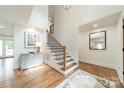 Bright foyer with hardwood floors, staircase with black iron railings, and soaring ceilings at 601 Cherokee Rd, Charlotte, NC 28207