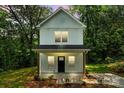 Charming two-story home with white siding, a covered porch, and simple landscaping at 605 Poplar St, Shelby, NC 28150