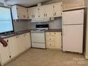 Functional kitchen with white cabinets, essential appliances, and a practical layout for cooking at 6544 Helens Way, Denver, NC 28037