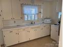 Bright kitchen showcasing classic cabinetry, a functional layout, and natural light from a window at 6544 Helens Way, Denver, NC 28037