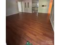 Inviting living room showcasing gleaming wood floors and a seamless transition into the kitchen at 6544 Helens Way, Denver, NC 28037