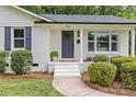 Up close view of the front door with white painted steps at 7219 Brynhurst Dr, Charlotte, NC 28210