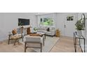Cozy living room with large windows allowing natural light to flow at 7219 Brynhurst Dr, Charlotte, NC 28210