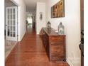 Bright entryway showcasing hardwood floors and decorative wooden console table at 7328 Strawberry Fields Ln, Charlotte, NC 28278