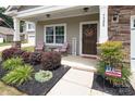 Inviting front porch with a Welcome sign, chairs, and decorative landscaping at 7328 Strawberry Fields Ln, Charlotte, NC 28278