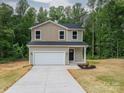 Inviting two-story home with a spacious driveway, attached garage, and landscaped front garden at 823 32Nd Ne St, Conover, NC 28613