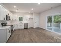 Bright, open kitchen with stainless appliances, white cabinets and wood-look floors at 823 32Nd Ne St, Conover, NC 28613