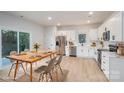 Bright, modern kitchen with white cabinets, stainless steel appliances, and an adjacent dining area at 823 32Nd Ne St, Conover, NC 28613