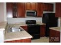 Efficient kitchen offers ample storage, a stainless steel microwave, and neutral countertops at 9823 Hyde Glen Ct, Charlotte, NC 28262