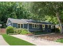 Charming single-story home featuring a freshly painted exterior, landscaped yard, and a welcoming front entrance at 1027 Dresden W Dr, Charlotte, NC 28205