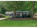 Charming single-story home featuring a freshly painted exterior, landscaped yard, and a welcoming front entrance at 1027 Dresden W Dr, Charlotte, NC 28205