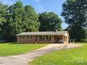 Charming brick ranch home with covered carport and paved driveway at 10414 Tillman Steen Rd, Indian Land, SC 29720