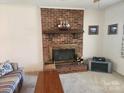 Cozy living room featuring a brick fireplace with decorative mantel at 10414 Tillman Steen Rd, Indian Land, SC 29720