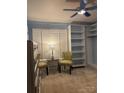 Bedroom with plantation shutters, walk in closet, dresser and accent chairs at 106 Condover Pl, Charlotte, NC 28270