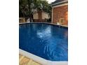 Enjoy the refreshing backyard pool with a brick house surround, creating a private oasis at 106 Condover Pl, Charlotte, NC 28270