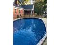 Backyard pool features a new wooden deck, lounge chair, and an outdoor gazebo for entertaining at 106 Condover Pl, Charlotte, NC 28270