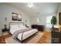Bright main bedroom showcasing hardwood floors, a modern bed frame, and tasteful decor at 11021 Travis Gulch Dr, Charlotte, NC 28277