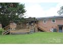 Expansive backyard features a wooden deck and patio area perfect for outdoor entertaining at 116 Woodbark Ln, Kings Mountain, NC 28086